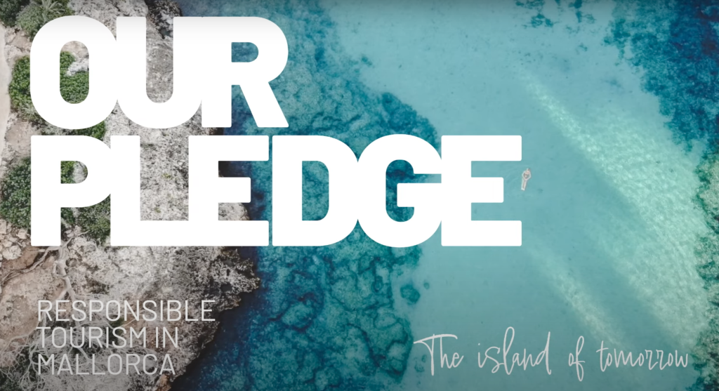 Aerial view of a rocky coastline meeting turquoise waters in Mallorca, with large white text reading “Our Pledge” and smaller text stating “Responsible Tourism in Mallorca – The island of tomorrow.”