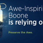 Graphic promoting Boone County tourism sustainability. A hiker stands on a rocky cliff at sunset, silhouetted inside the shape of a reusable water bottle. Text reads: “Awe-Inspiring Boone is relying on us. Preserve the Awe.”