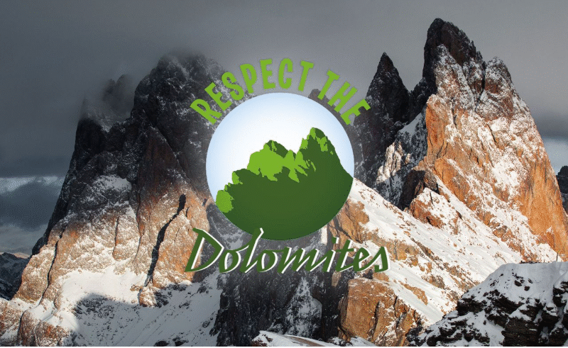 Snow-covered peaks of the Dolomites with the “Respect the Dolomites” emblem overlaid, symbolizing responsible travel and care for fragile mountain ecosystems.Snow-covered peaks of the Dolomites with the “Respect the Dolomites” emblem overlaid, symbolizing responsible travel and care for fragile mountain ecosystems.